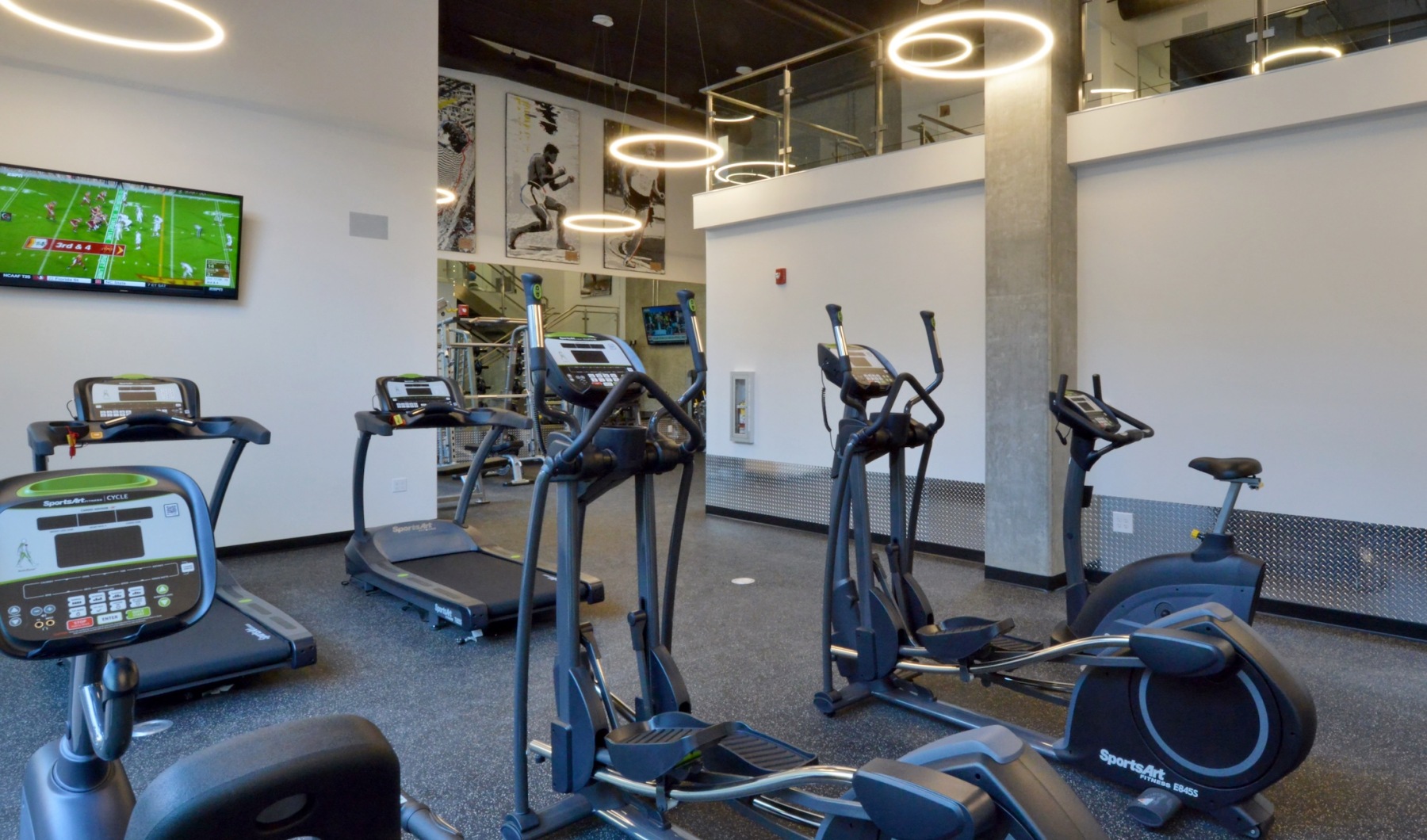 fitness center with open spaces and bright lighting through the windows